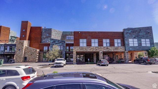 1456 W Newpark Blvd Unit 213, Park City, UT 84098 - view of building exterior featuring uncovered parking