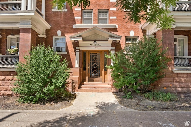 310 S 300 E Unit A2, Salt Lake City, UT 84111 - entrance to property featuring brick siding, cooling unit, and a balcony