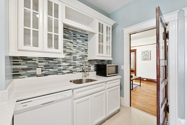 310 S 300 E Unit A2, Salt Lake City, UT 84111 - kitchen with white dishwasher, stainless steel microwave, backsplash, and glass insert cabinets