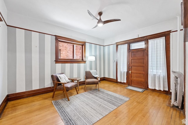 310 S 300 E Unit A2, Salt Lake City, UT 84111 - living area featuring light wood finished floors, a ceiling fan, wallpapered walls, and plenty of natural light