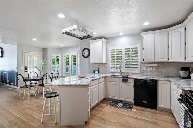 1964 N 2000 E, Layton, UT 84040 - kitchen with black appliances, a peninsula, white cabinetry, light wood-style flooring, and recessed lighting