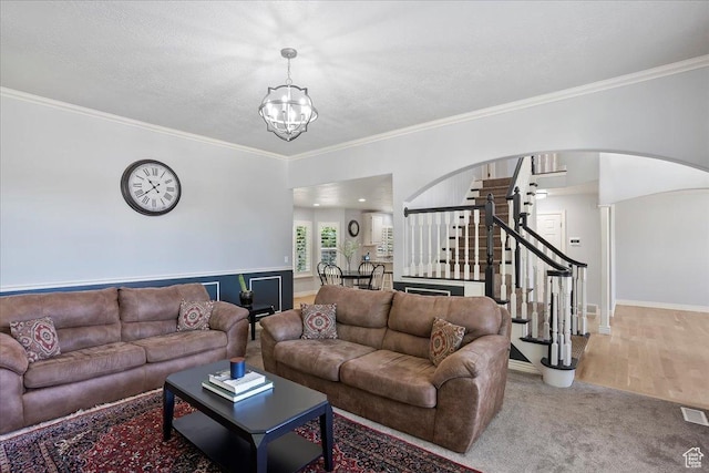 1964 N 2000 E, Layton, UT 84040 - carpeted living area with a chandelier, stairs, arched walkways, crown molding, and a textured ceiling