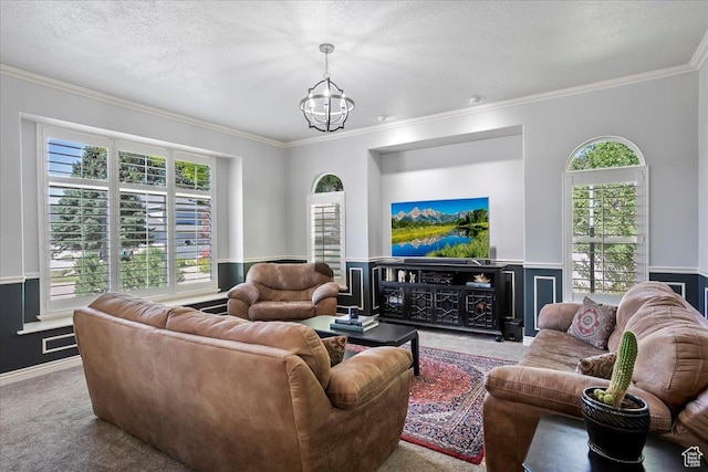 1964 N 2000 E, Layton, UT 84040 - living room featuring carpet flooring, crown molding, a chandelier, plenty of natural light, and a wainscoted wall