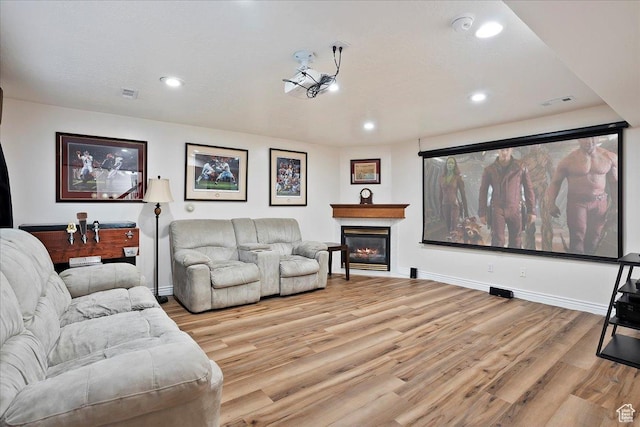 1964 N 2000 E, Layton, UT 84040 - home theater with light wood-style floors, recessed lighting, and a glass covered fireplace
