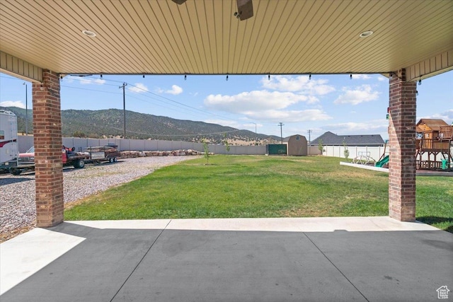 216 E 1370 S, Nephi, UT 84648 - fenced backyard with a patio, a mountain view, a playground, and a storage shed