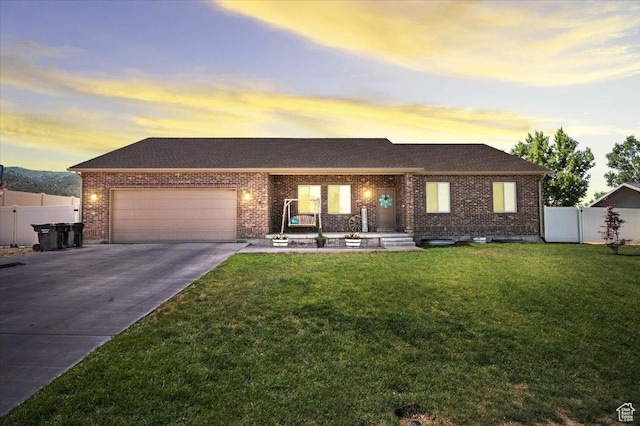 216 E 1370 S, Nephi, UT 84648 - view of front of house with driveway, an attached garage, brick siding, and a porch