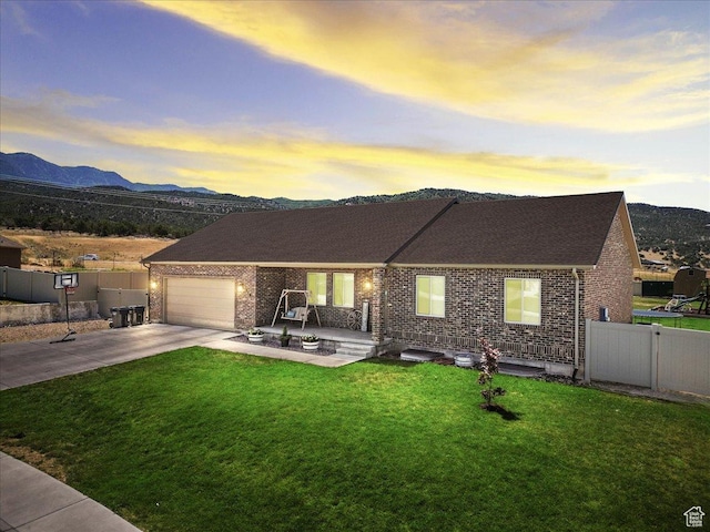 216 E 1370 S, Nephi, UT 84648 - view of front of house with brick siding, driveway, a mountain view, a garage, and a shingled roof