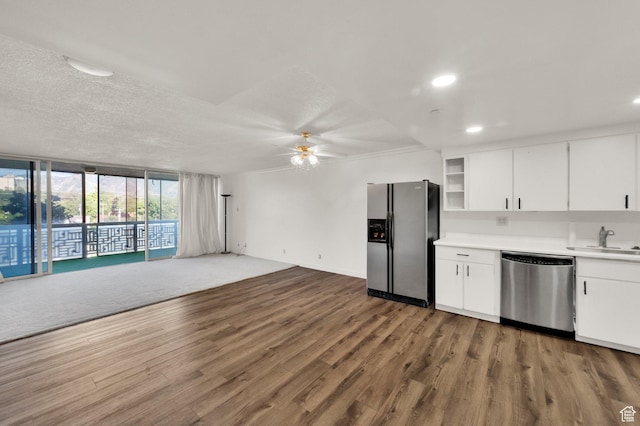 515 S 1000 E Unit 706, Salt Lake City, UT 84102 - kitchen with stainless steel appliances, a ceiling fan, wood finished floors, light countertops, and white cabinetry