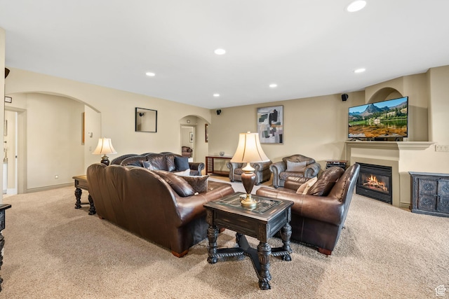 364 N Tanner Ln, Midway, UT 84049 - carpeted living room featuring arched walkways, recessed lighting, and a glass covered fireplace