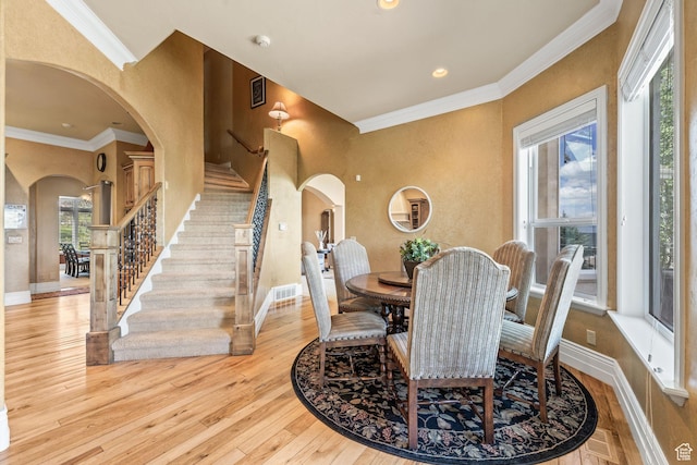 364 N Tanner Ln, Midway, UT 84049 - dining space with arched walkways, stairway, light wood-style flooring, ornamental molding, and recessed lighting