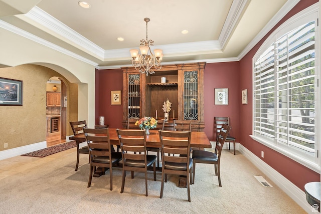 364 N Tanner Ln, Midway, UT 84049 - dining room featuring healthy amount of natural light, arched walkways, a chandelier, a tray ceiling, and crown molding