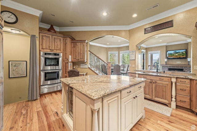 364 N Tanner Ln, Midway, UT 84049 - kitchen featuring arched walkways, double oven, a warming drawer, light wood-style floors, and recessed lighting