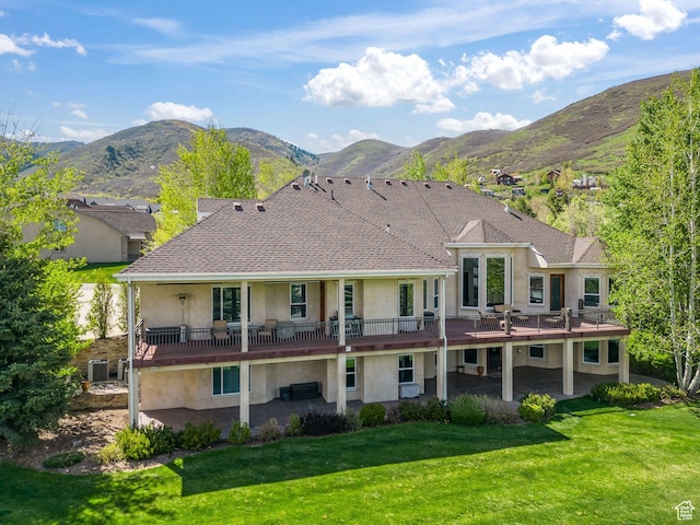364 N Tanner Ln, Midway, UT 84049 - rear view of property with stucco siding, a patio, a yard, a deck with mountain view, and roof with shingles