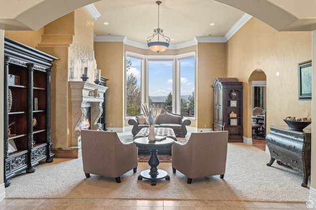 364 N Tanner Ln, Midway, UT 84049 - tiled living room with arched walkways, crown molding, a lit fireplace, and recessed lighting