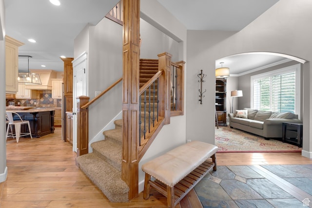 916 Ledgestone Ln, Heber City, UT 84032 - stairs with arched walkways, hardwood / wood-style flooring, recessed lighting, and ornamental molding
