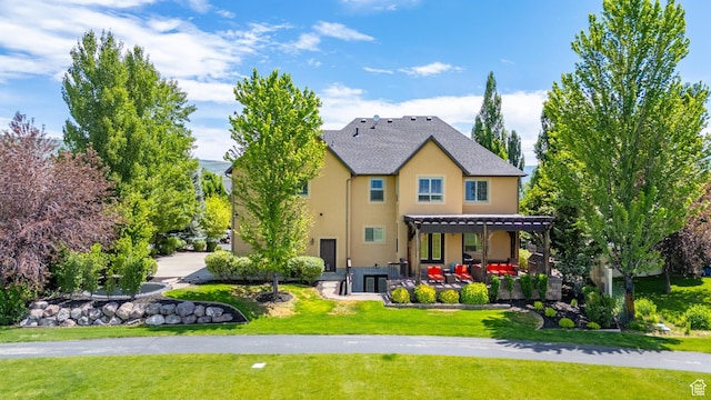 916 Ledgestone Ln, Heber City, UT 84032 - rear view of property with stucco siding, a patio area, and a yard