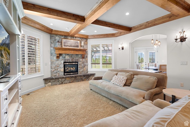 916 Ledgestone Ln, Heber City, UT 84032 - living room featuring beamed ceiling, coffered ceiling, arched walkways, a fireplace, and carpet floors