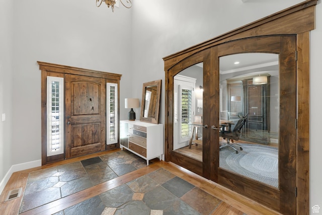 916 Ledgestone Ln, Heber City, UT 84032 - entrance foyer featuring stone tile floors, french doors, a towering ceiling, and arched walkways