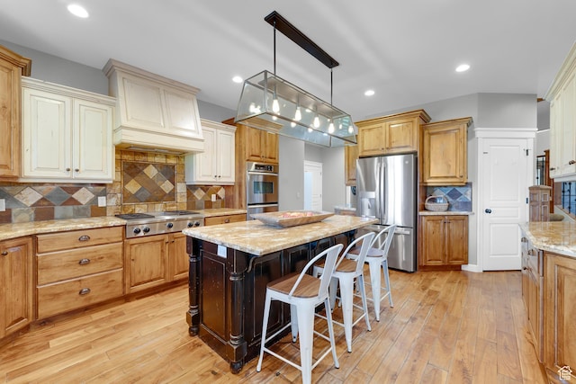 916 Ledgestone Ln, Heber City, UT 84032 - kitchen with appliances with stainless steel finishes, light wood-style floors, decorative backsplash, a breakfast bar, and recessed lighting