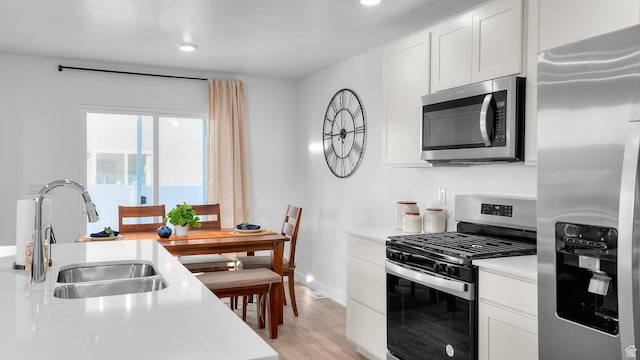 1538 E 720 N Unit 1083, Salem, UT 84653 - kitchen featuring stainless steel appliances, light countertops, white cabinetry, light wood-style floors, and recessed lighting