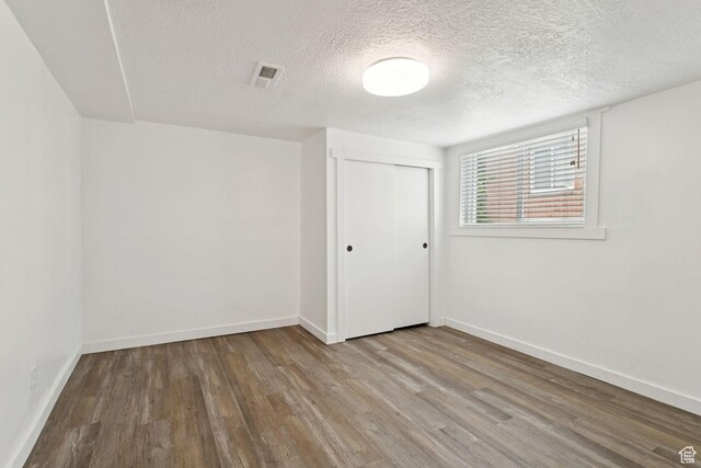 1163 E Blaine Ave, Salt Lake City, UT 84105 - empty room featuring wood finished floors and a textured ceiling