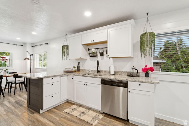 1163 E Blaine Ave, Salt Lake City, UT 84105 - kitchen with stainless steel dishwasher, light wood-type flooring, white cabinets, a peninsula, and recessed lighting