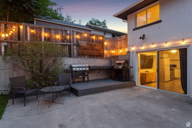 1163 E Blaine Ave, Salt Lake City, UT 84105 - patio terrace at dusk featuring a patio, grilling area, and a wooden deck