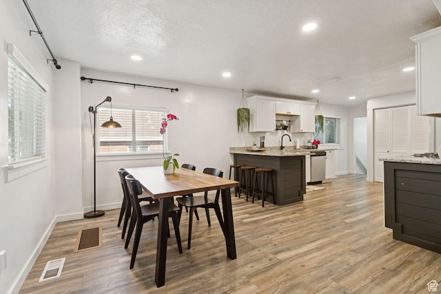 1163 E Blaine Ave, Salt Lake City, UT 84105 - dining room with plenty of natural light, light wood finished floors, recessed lighting, and a textured ceiling