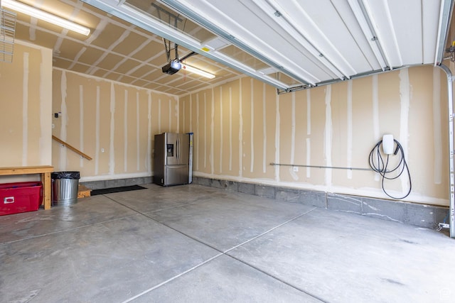 1107 W Coyote Gulch Way, Bluffdale, UT 84065 - garage featuring stainless steel fridge with ice dispenser and a garage door opener
