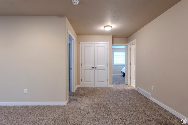 1107 W Coyote Gulch Way, Bluffdale, UT 84065 - unfurnished bedroom featuring carpet, a closet, and a textured ceiling
