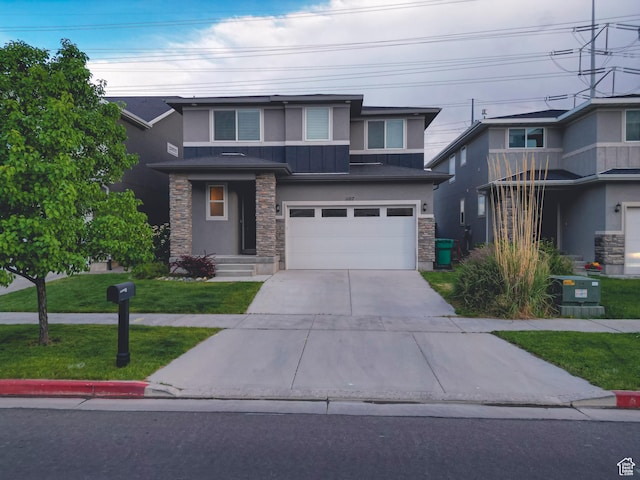 1107 W Coyote Gulch Way, Bluffdale, UT 84065 - prairie-style house with stone siding, stucco siding, concrete driveway, an attached garage, and a front yard