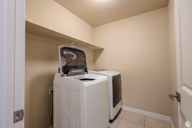 1107 W Coyote Gulch Way, Bluffdale, UT 84065 - washroom with washing machine and dryer, light tile patterned floors, and a textured ceiling