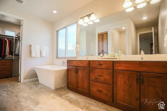 2893 W Nemi Ln, St George, UT 84770 - full bath with double vanity, a soaking tub, a walk in closet, and recessed lighting