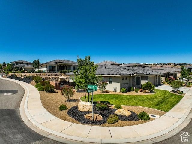2893 W Nemi Ln, St George, UT 84770 - view of front of property with an attached garage, a front yard, a residential view, and driveway