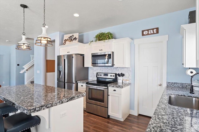 64 W 470 N, Vineyard, UT 84059 - kitchen featuring appliances with stainless steel finishes, dark wood finished floors, tasteful backsplash, and white cabinets