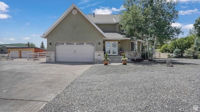 6195 Highland Dr, Park City, UT 84098 - view of front of home with stucco siding, stone siding, driveway, french doors, and an attached garage