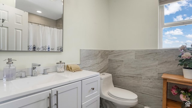 6195 Highland Dr, Park City, UT 84098 - bathroom featuring tile walls, vanity, and a wainscoted wall