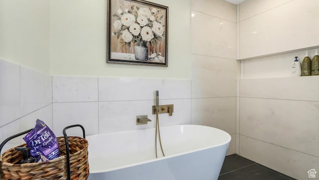 6195 Highland Dr, Park City, UT 84098 - bathroom featuring a soaking tub, tile patterned flooring, and tile walls