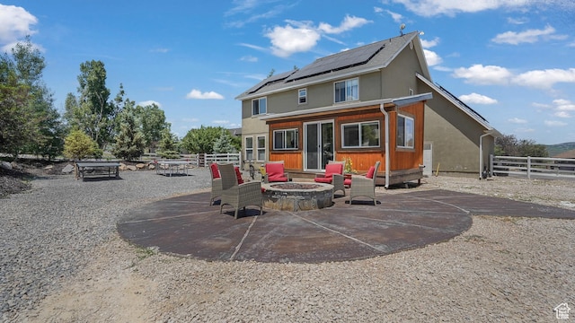 6195 Highland Dr, Park City, UT 84098 - rear view of house featuring a fire pit, solar panels, and a patio