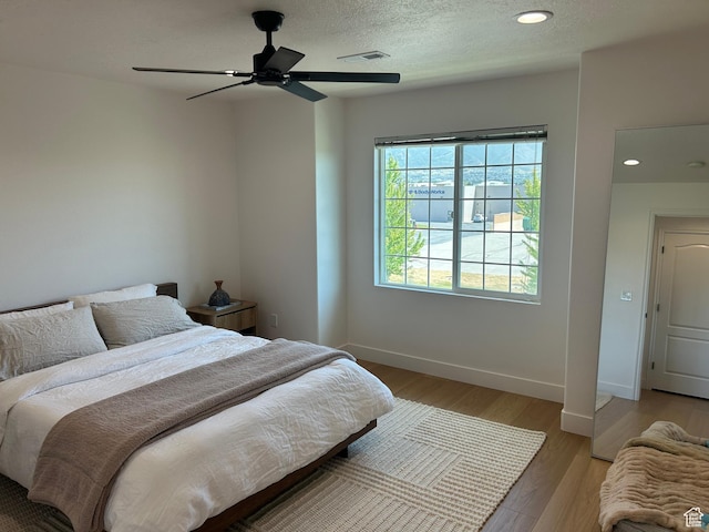 164 E Spencer Peak Way S Unit A11, Draper, UT 84020 - bedroom featuring light wood-style floors, a ceiling fan, recessed lighting, and a textured ceiling