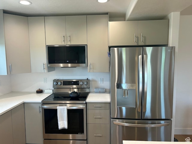 164 E Spencer Peak Way S Unit A11, Draper, UT 84020 - kitchen featuring appliances with stainless steel finishes, gray cabinetry, light countertops, and recessed lighting