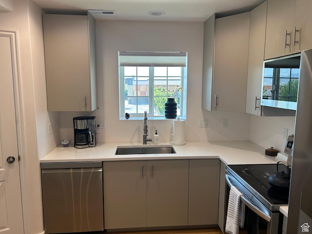 164 E Spencer Peak Way S Unit A11, Draper, UT 84020 - kitchen with appliances with stainless steel finishes, gray cabinets, and light countertops