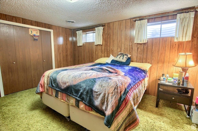 1184 16th St Unit B, Ogden, UT 84404 - carpeted bedroom featuring wooden walls, a textured ceiling, and a closet