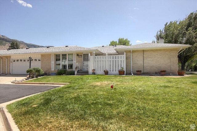 1184 16th St Unit B, Ogden, UT 84404 - ranch-style home featuring asphalt driveway, brick siding, an attached garage, and a chimney
