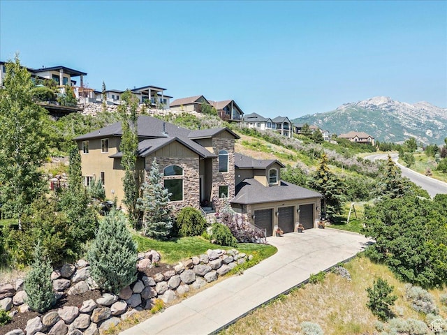 1487 E Deer Ridge Dr, Draper, UT 84020 - view of front facade with stone siding, driveway, a mountain view, and an attached garage