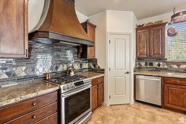 1487 E Deer Ridge Dr, Draper, UT 84020 - kitchen featuring stainless steel appliances, custom range hood, decorative backsplash, and stone counters