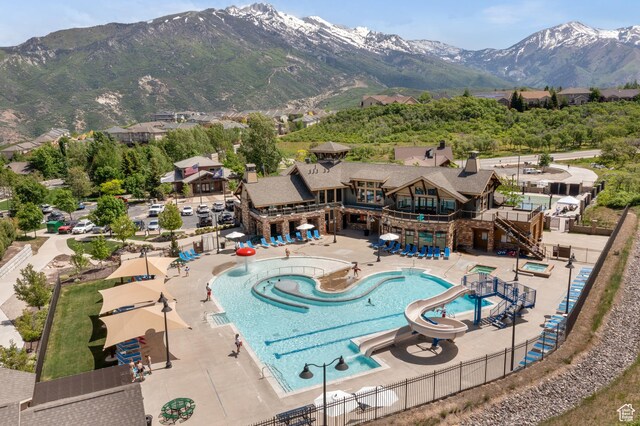 1487 E Deer Ridge Dr, Draper, UT 84020 - community pool featuring a mountain view, a patio, a water slide, and a residential view
