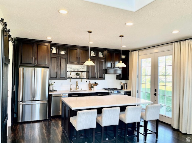 14312 S Herriman View Way, Herriman, UT 84096 - kitchen featuring stainless steel appliances, light countertops, dark brown cabinets, dark wood-type flooring, and recessed lighting
