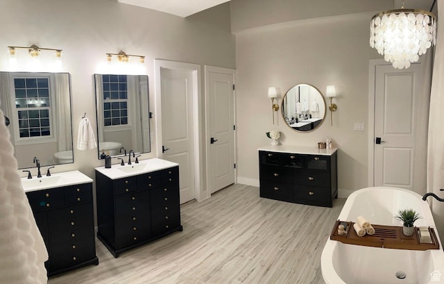 14312 S Herriman View Way, Herriman, UT 84096 - full bathroom featuring two vanities, wood finished floors, a freestanding bath, and a chandelier