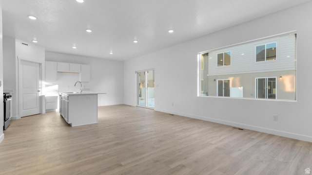 838 N 1860 E Unit 161, Salem, UT 84653 - kitchen featuring recessed lighting, light wood-style flooring, a center island with sink, white cabinetry, and open floor plan